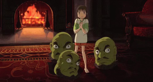 Chihiro in Yubaba's office, on the Persian rug in front fo the fireplace, surrounded by Yubaba's pet green giant heads of men with beards, who are bouncing around her.
